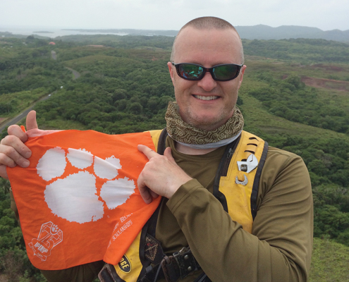 Micronesia Brad Blackburn ’97 displays his Clemson pride with a Tiger Rag that traveled more than 22,000 miles to the islands of Pohnpei, Yap and Palau.