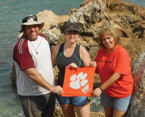 Haiti Robert ’98 and Walker Massey, and Debbie Peek show off a Tiger Rag in a Caribbean cove.