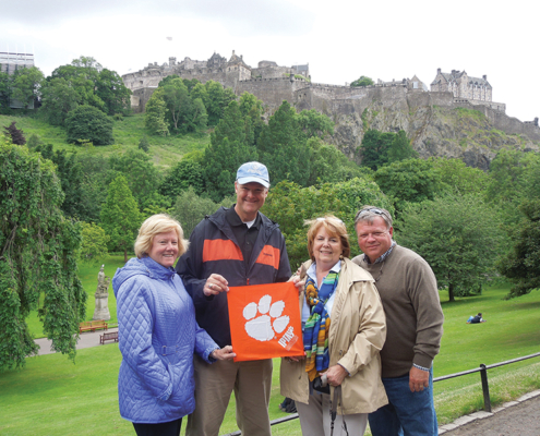 Scotland *Kathy Davis ’76 and *David Sudduth ’90, M ’98 proudly show their Tiger Rag in beautiful Edinburgh with Stephanie and Mike Taylor ’76, M ’78.