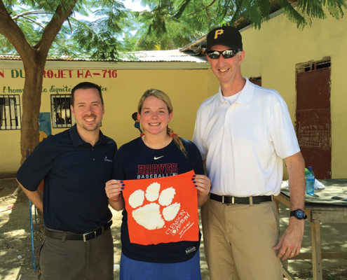 Haiti Andy Russell ’99, Rustin Cassels ’12 and Rob Porter ’93 display a Tiger Rag while on a mission trip with Compassion International.