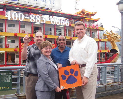 China Stan Jablonski ’05, June Opitz Satterfield ’82, Fritz Moise Jr. ’90 and *Ty Cobb Jr. ’79 made sure to take their Clemson pride with them on their business trip to China.