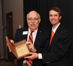Jim Bull (left) receives the Volunteer of the Year award from Wil Brasington, executive director of Alumni Relations.