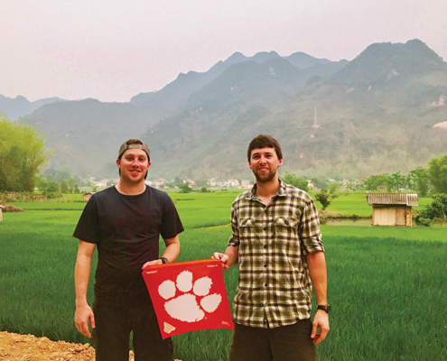 Tyler Youngman ’13 and John Launius ’11 show their Tiger pride while motorbiking through rural Vietnam.