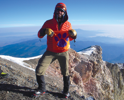 Rhett Mitchell III ’05 shares his second-generation Tiger Rag at the top of Pico de Orizaba, 18,491' elevation. The Tiger Rag is from Rhett Mitchell Jr. ’79* who has owned it since 1975.