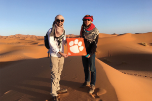Zack Geiger ’13 and Andy Burns ’15 took a three-day tour through the Sahara Desert near Merzouga, Morocco. The pair rode camels into the desert, snapping a picture on the sands with their Tiger Rag on the way to a nomadic campsite. “It was an exhilarating trip made all the more exciting by angry, spitting camels and our guide quitting on day two after a dispute with the driver. It truly was the trip of a lifetime,” Burns says.