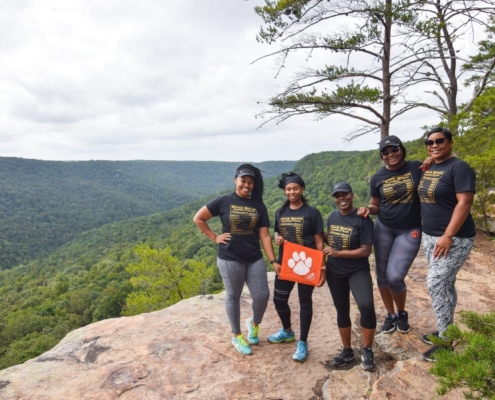 Tennessee: From left to right, Candace Hall ’10, Lyndsey Williams Mayweather ’10, April Smith ’08, Alexia Richardson ’10 and Nyamekyer Sonja Badu ’11 celebrated their 32nd birthdays in the mountains of Tennessee on a hiking trip led by fellow Clemson alum Ryan Maum ’17, who owns and operates Experience Chattanooga. Ryan shot the photo of the group on the overlook of Cumberland Mountain. “We celebrated our 19th birthdays together in Calhoun Courts and have been celebrating together ever since!” wrote Lynsey.