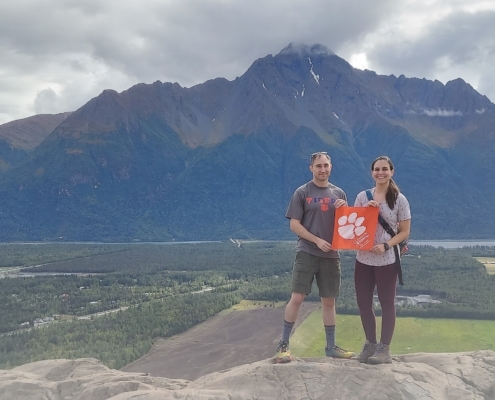 Alaska: Twins Sarah ’14 and Sam ’14 Grosse stopped for a photo with their Tiger Rag in front of Bodenburg Butte, a mountain in the Matanuska Valley of Palmer, Alaska.